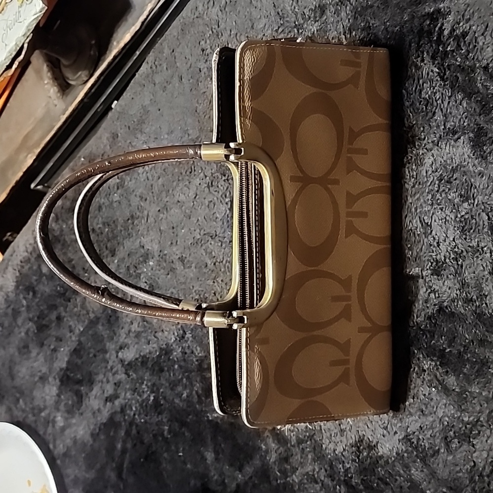 Women's purse, very clean and barely used. Tan with designs and brown leather.